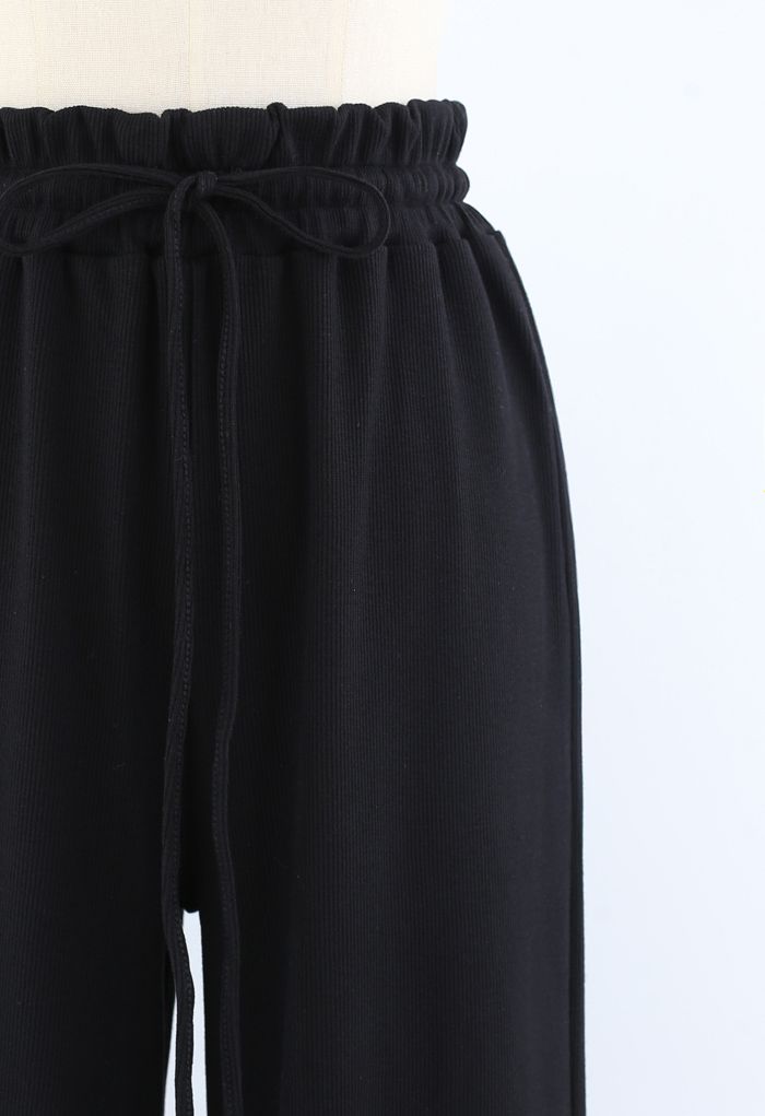 Pantalones de yoga acanalados con cintura de bolsa de papel con cordón en negro