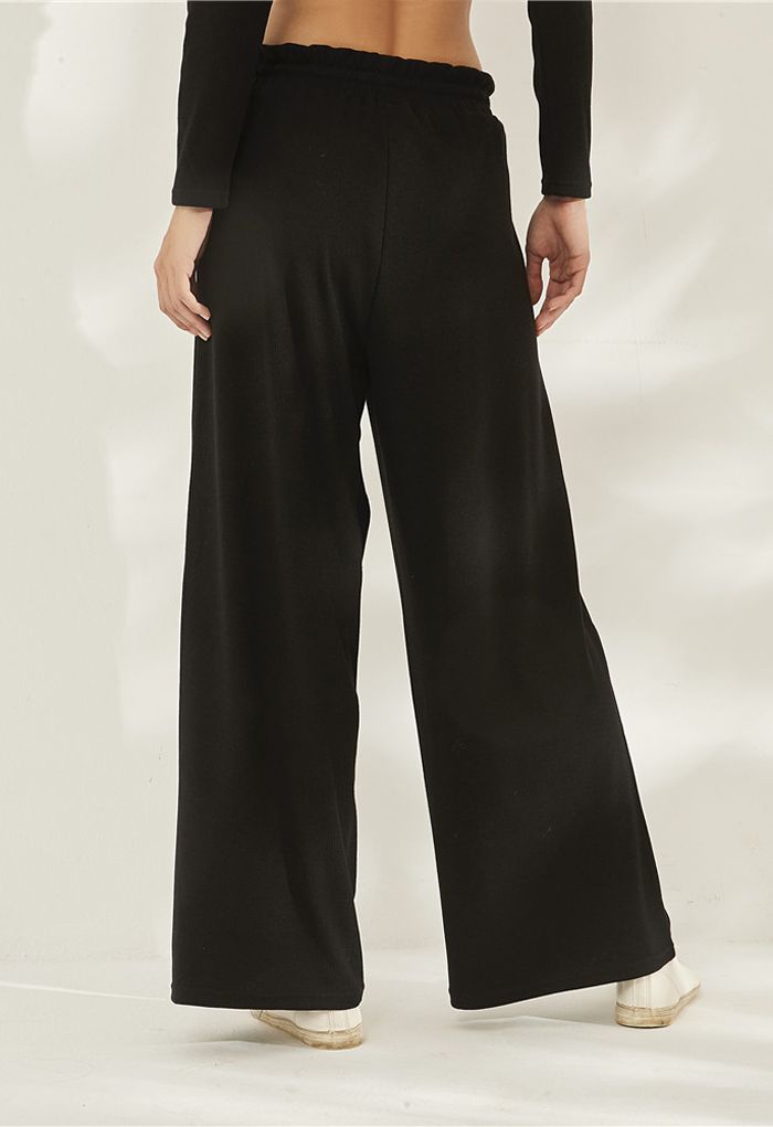 Pantalones de yoga acanalados con cintura de bolsa de papel con cordón en negro